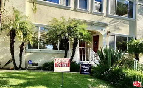 a view of sign board with tall buildings