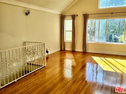 a view of a balcony with wooden floor