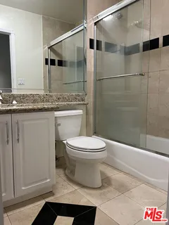 a bathroom with a toilet a sink and shower