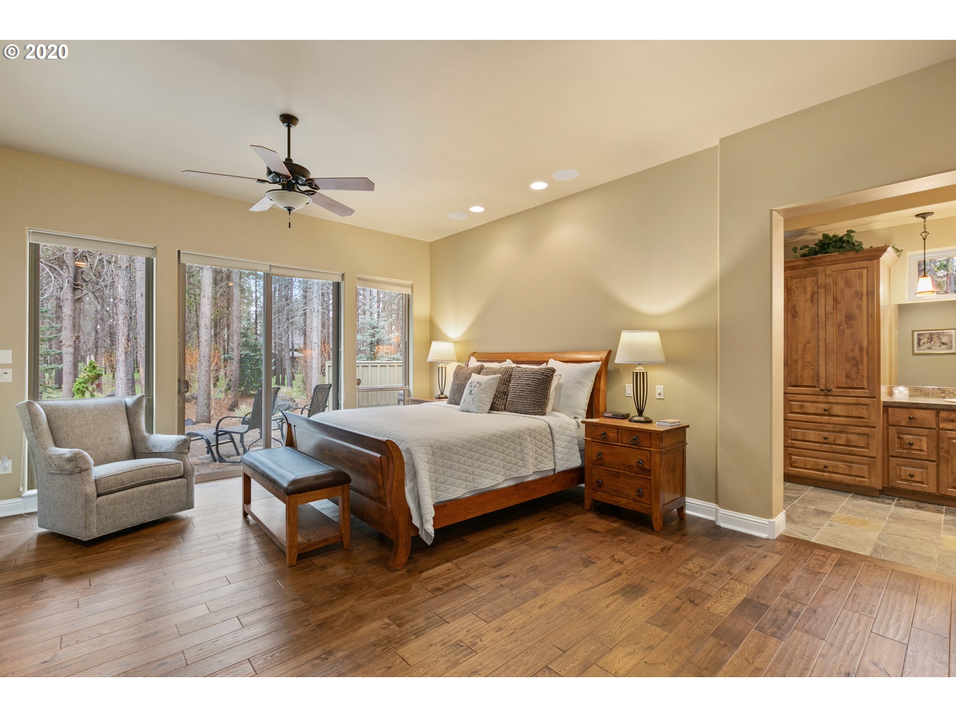 16767 Stage Stop Drive Bend, OR 97707 - Photo 11 of 26 a spacious bedroom with a bed a couch and a window
