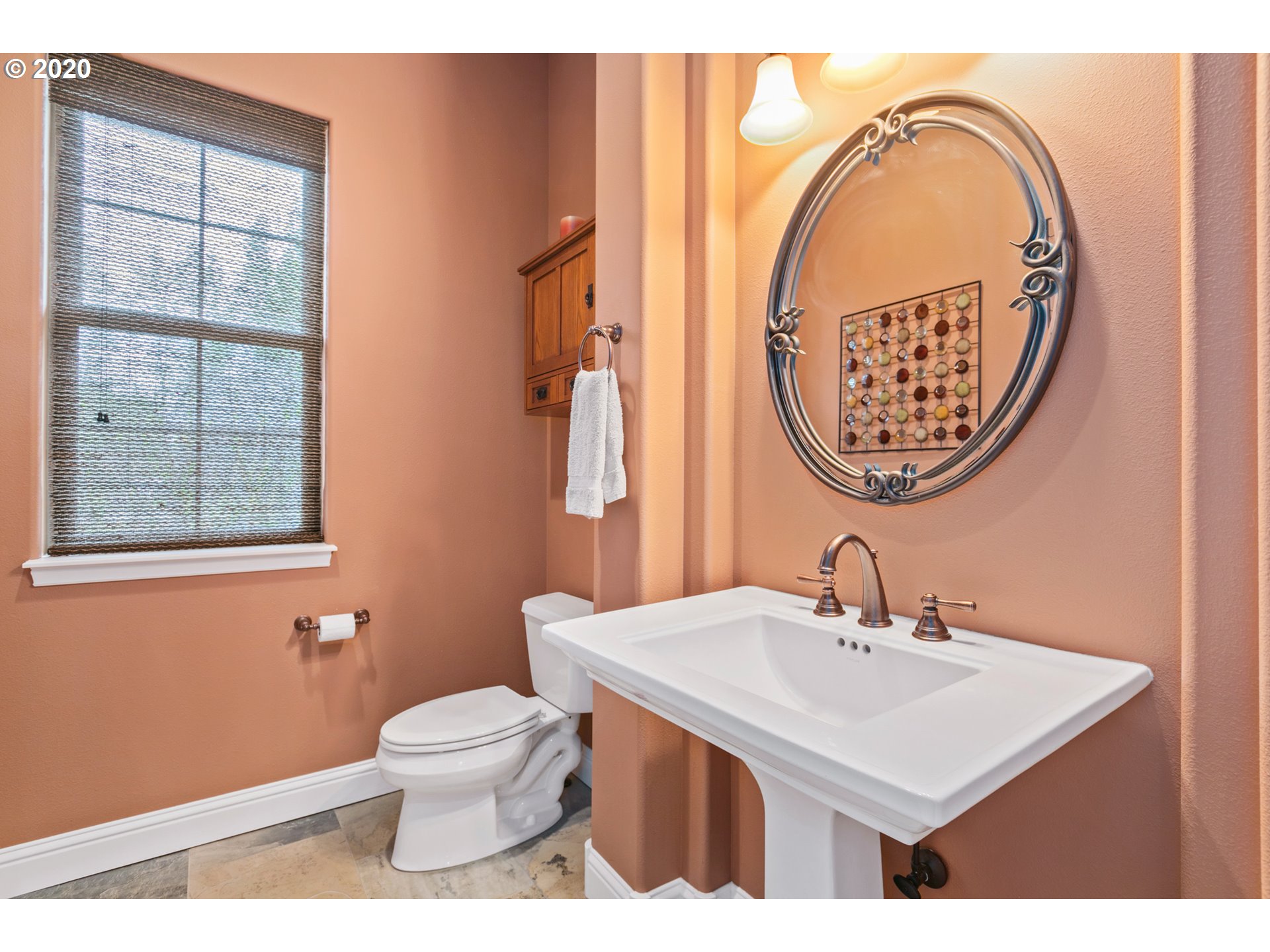 16767 Stage Stop Drive Bend, OR 97707 - Photo 18 of 26 a bathroom with a toilet a sink and a mirror