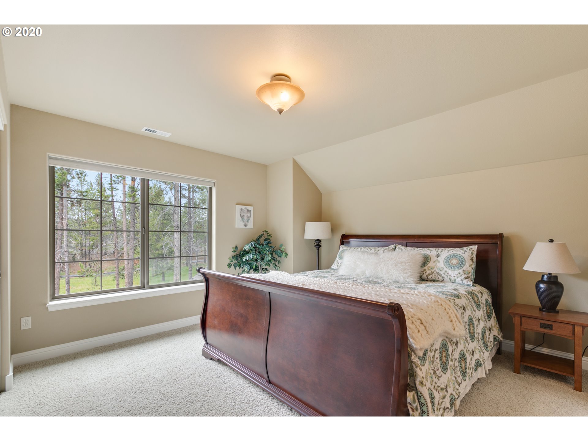 16767 Stage Stop Drive Bend, OR 97707 - Photo 19 of 26 a bed sitting in a bedroom next to a window