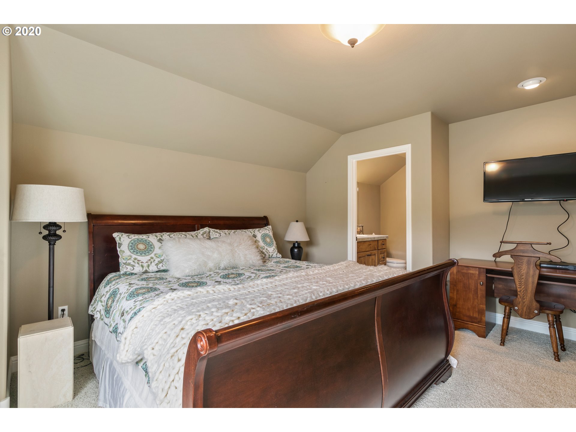 16767 Stage Stop Drive Bend, OR 97707 - Photo 20 of 26 a bedroom with a bed and a desk