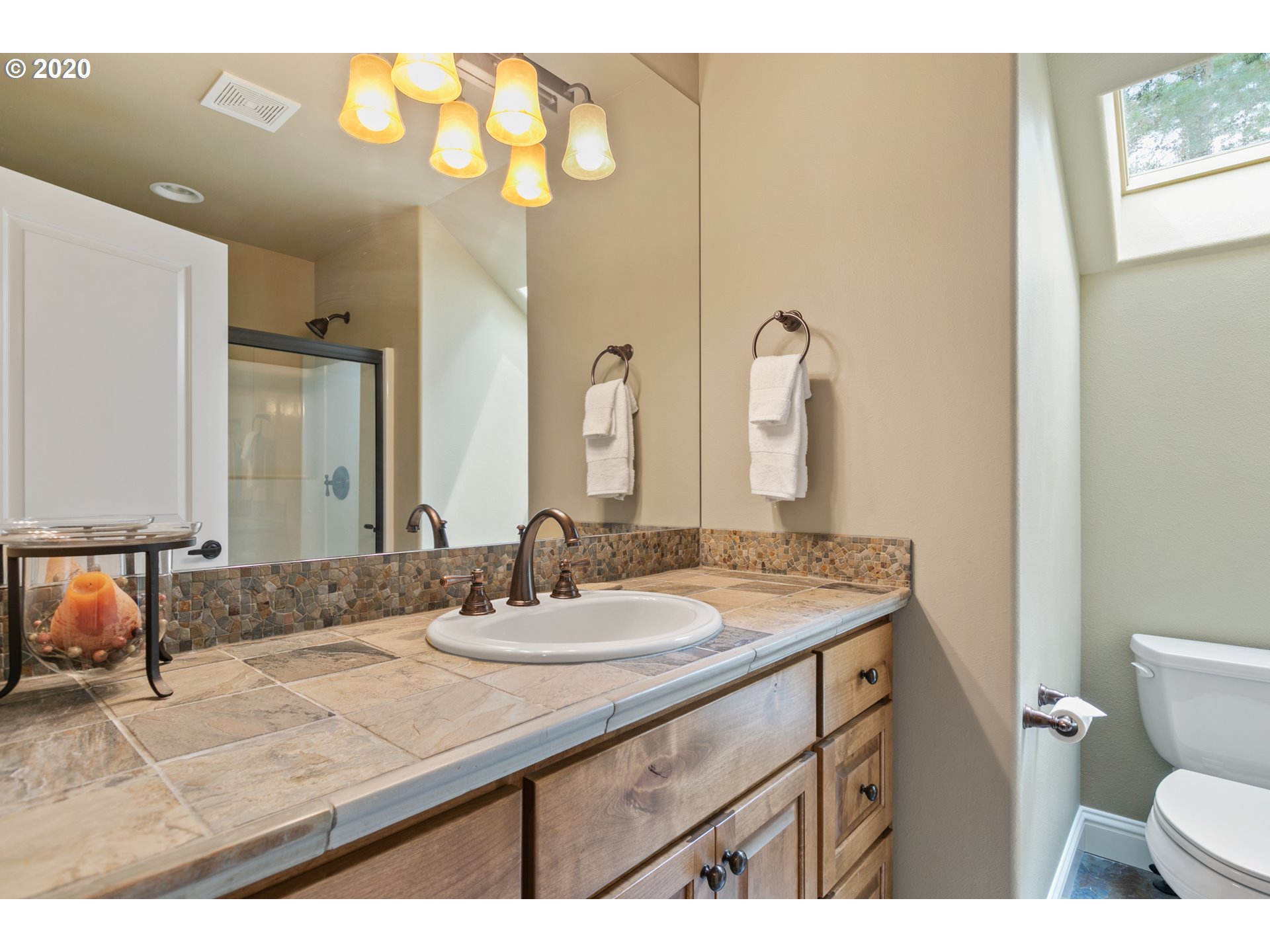 16767 Stage Stop Drive Bend, OR 97707 - Photo 22 of 26 a bathroom with a granite countertop sink mirror and toilet