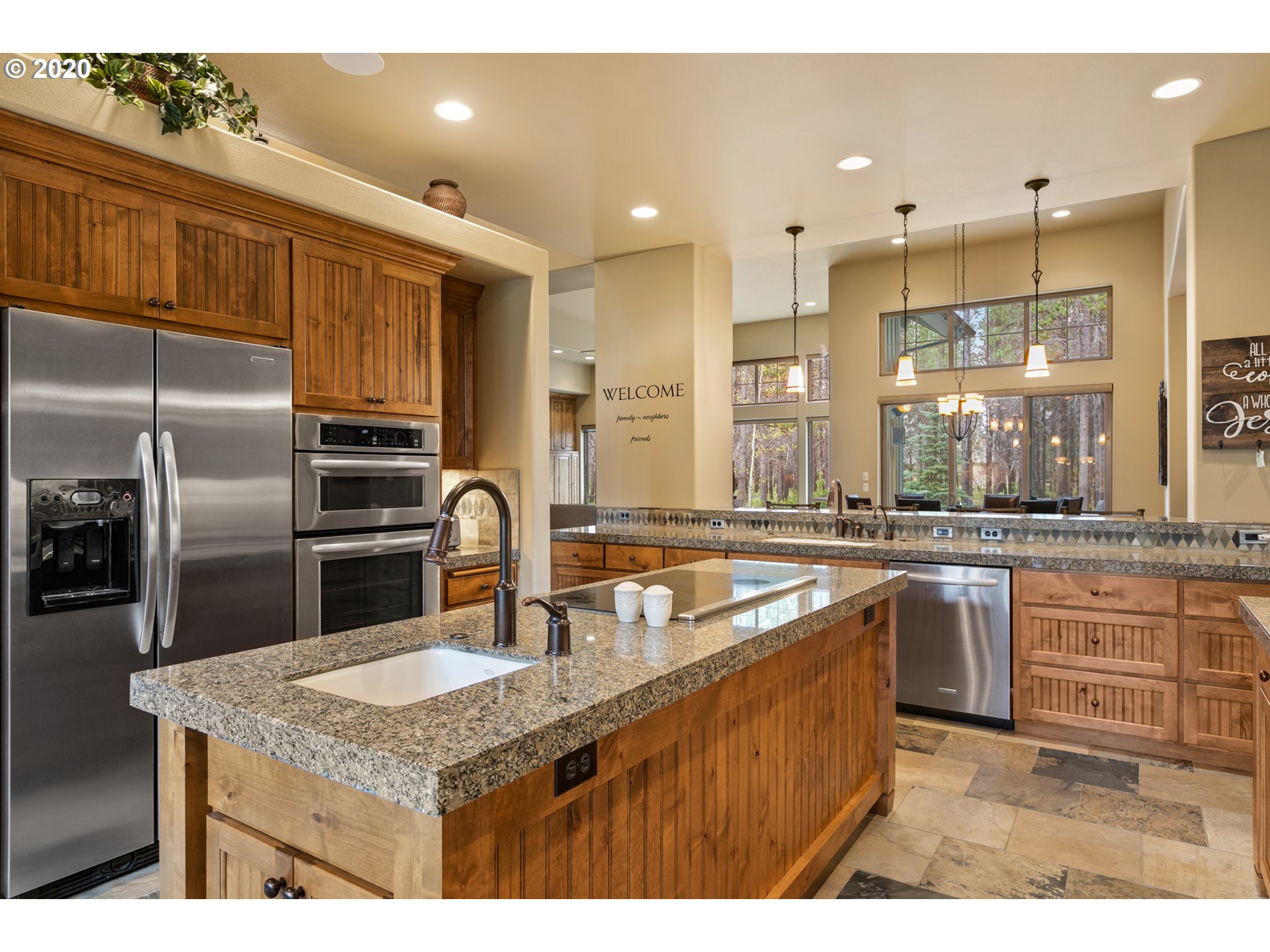 16767 Stage Stop Drive Bend, OR 97707 - Photo 8 of 26 a kitchen with stainless steel appliances granite countertop a sink a stove and a refrigerator