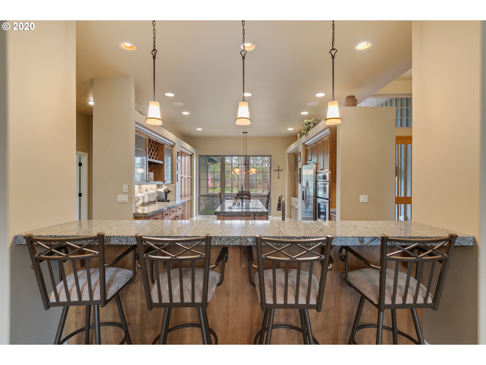 16767 Stage Stop Drive Bend, OR 97707 - Photo 9 of 26 a view of a a dining room with furniture window and wooden floor