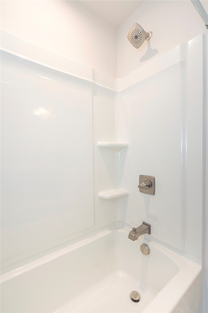 233 Scenic Road Anderson, SC 29621 - Photo 45 of 50 A pristine white tub and shower combination awaits a refreshing soak.