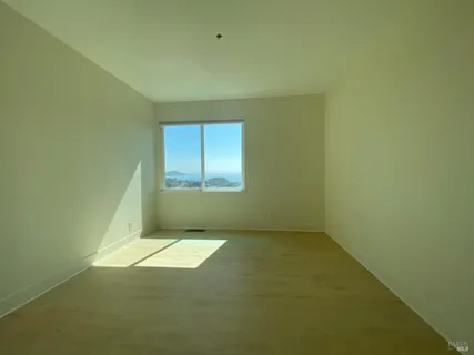 an empty room with a empty space and windows