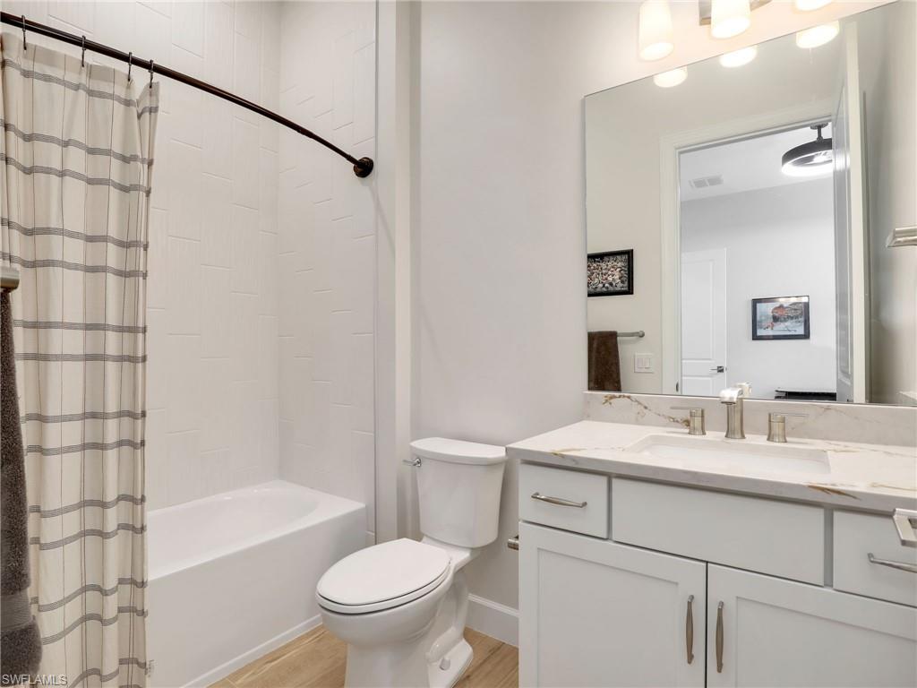 18412 Ridgeline Drive Estero, FL 33928 - Photo 37 of 50 a bathroom with a sink toilet vanity and shower