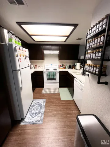 a kitchen with stainless steel appliances kitchen island granite countertop a refrigerator and a stove top oven