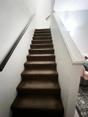 an empty room with closet and wooden door