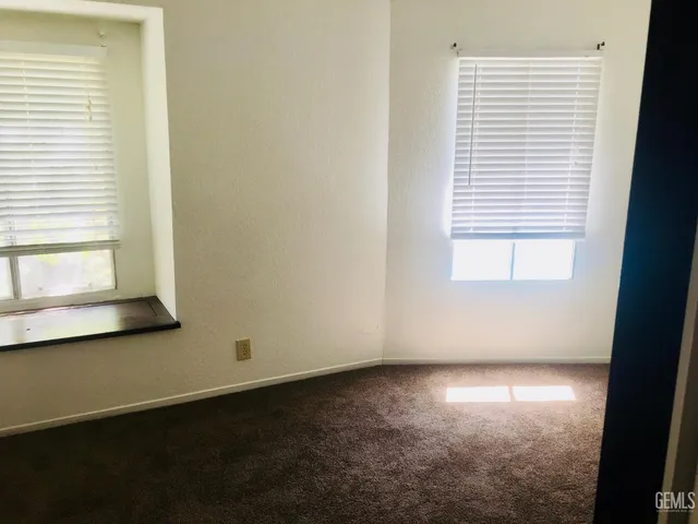 a bed sitting in a bedroom next to a mirror