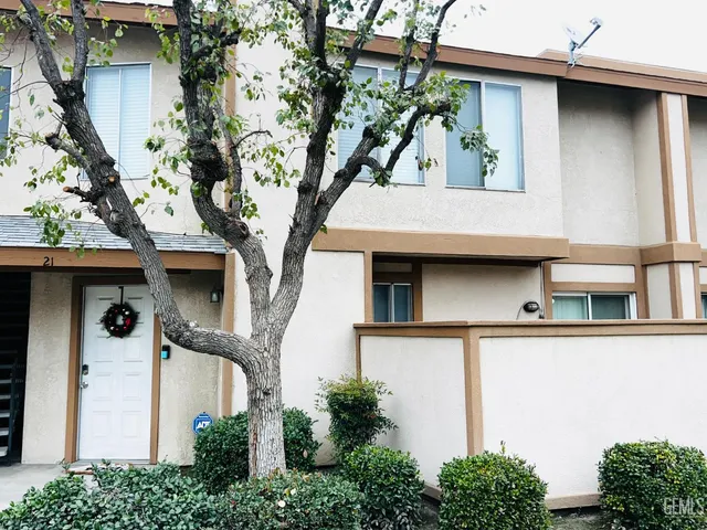 front view of a house with a tree
