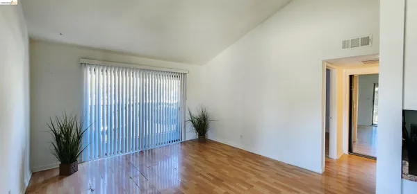 an empty room with wooden floor and a window