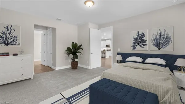 a spacious bedroom with a bed and a potted plant