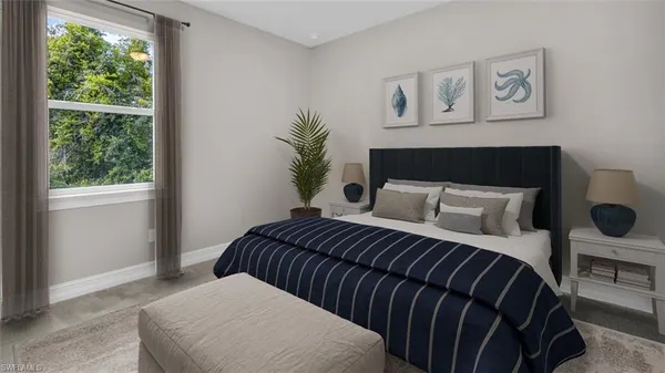 a bedroom with a large bed and a window