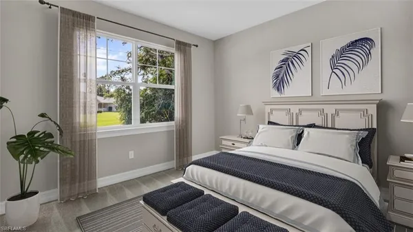a bedroom with a large bed and a window