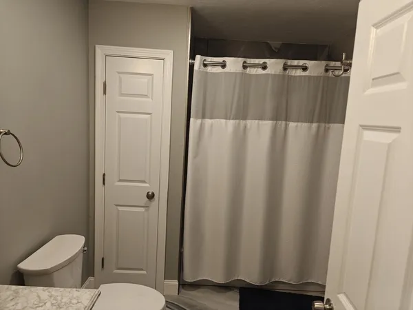 a bathroom with a shower curtain and sink
