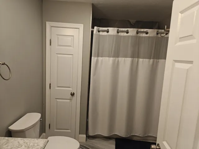 a bathroom with a shower curtain and sink