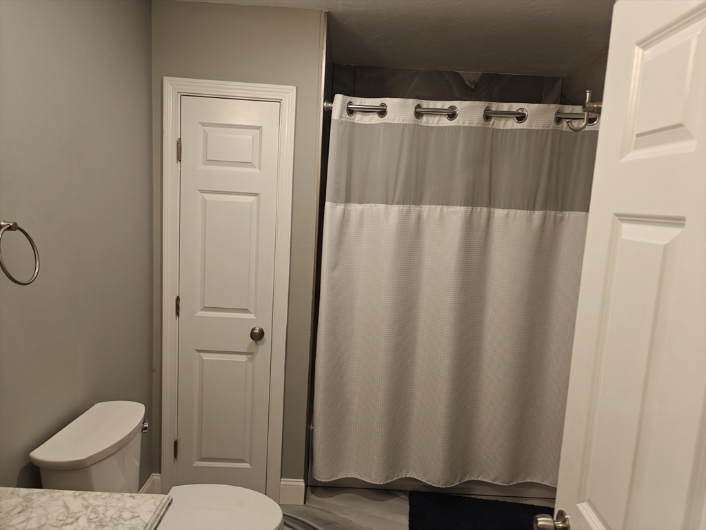 105 Holyoke Street, Unit 2 Lynn, MA 01905 - Photo 13 of 20 a bathroom with a shower curtain and sink