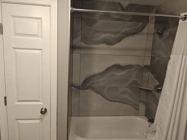 a bathroom with a glass shower door