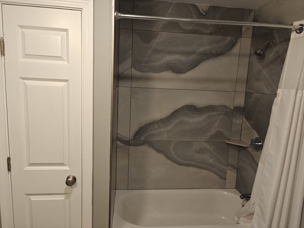 105 Holyoke Street, Unit 2 Lynn, MA 01905 - Photo 14 of 20 a bathroom with a glass shower door