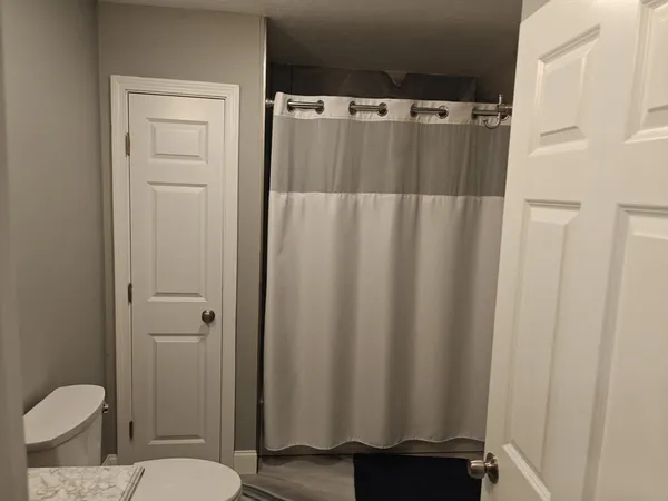 a bathroom with a shower curtain and a sink