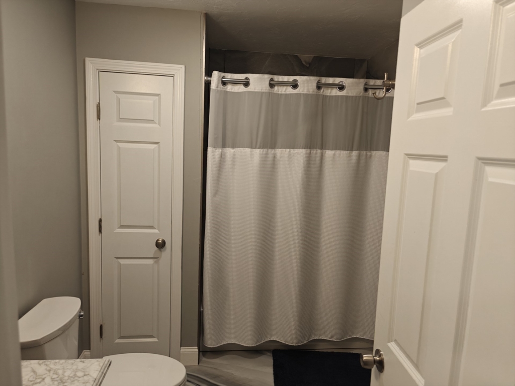 105 Holyoke Street, Unit 2 Lynn, MA 01905 - Photo 15 of 20 a bathroom with a shower curtain and a sink