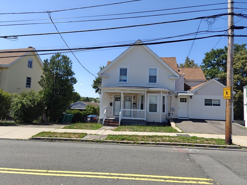 105 Holyoke Street, Unit 2 Lynn, MA 01905 - Photo 17 of 20 a view of a white house with a large pool in front of it