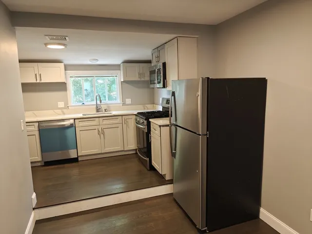 a kitchen with stainless steel appliances granite countertop a refrigerator and a sink