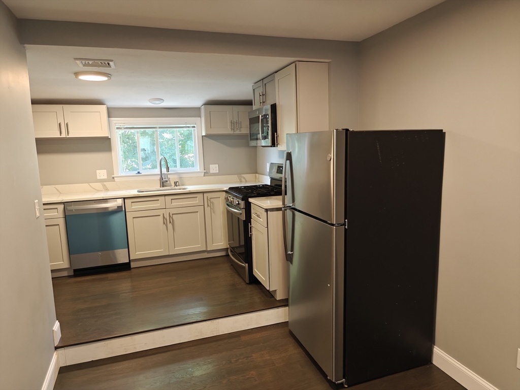 105 Holyoke Street, Unit 2 Lynn, MA 01905 - Photo 2 of 20 a kitchen with stainless steel appliances granite countertop a refrigerator and a sink