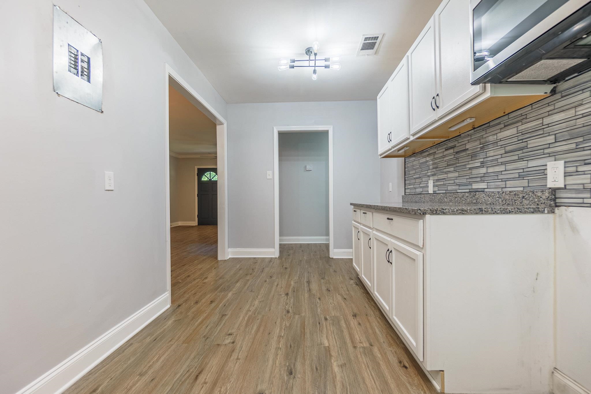2418 Vanderbilt Road Memphis, TN 38106 - Photo 7 of 16 a hallway with granite countertop wooden floor
