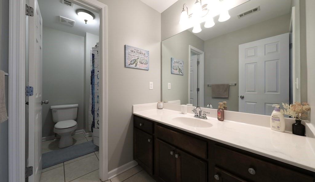 8680 Copperridge Drive Winston, GA 30187 - Photo 11 of 58 a bathroom with a sink a toilet and a mirror