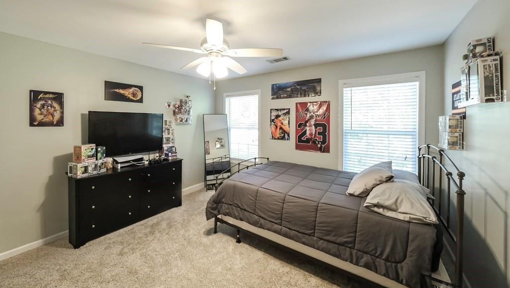 8680 Copperridge Drive Winston, GA 30187 - Photo 13 of 58 a bedroom with a bed and a flat screen tv