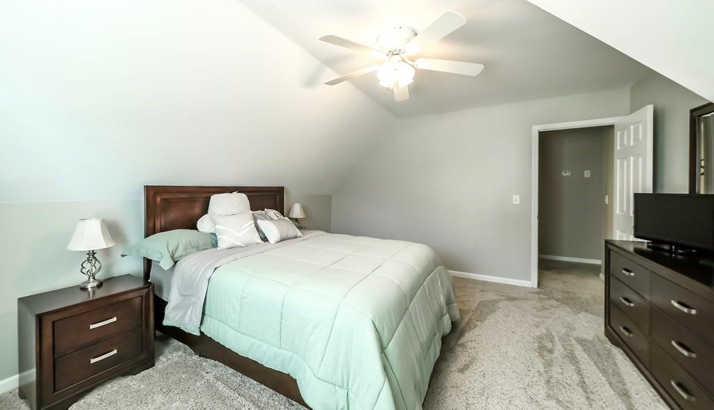 8680 Copperridge Drive Winston, GA 30187 - Photo 16 of 58 a bedroom with a bed and a tv on the dresser