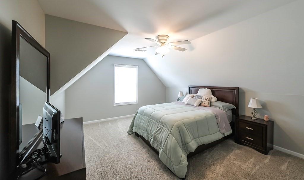 8680 Copperridge Drive Winston, GA 30187 - Photo 17 of 58 a bedroom with a bed and a chandelier