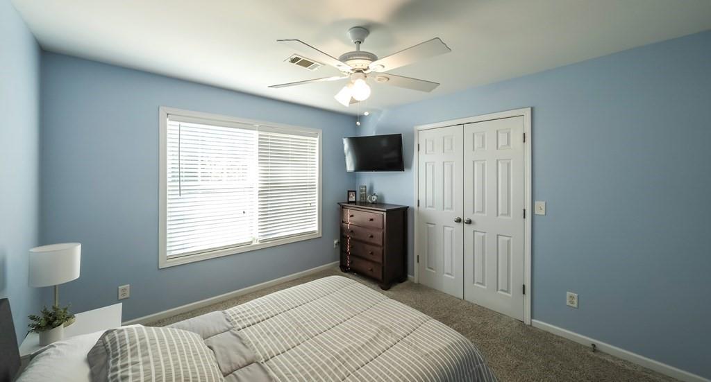 8680 Copperridge Drive Winston, GA 30187 - Photo 18 of 58 a bedroom with a bed and a chandelier