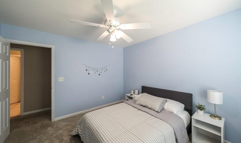 8680 Copperridge Drive Winston, GA 30187 - Photo 19 of 58 a bedroom with a bed and a ceiling fan