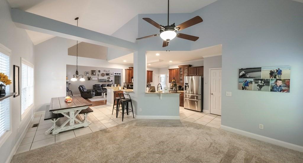 8680 Copperridge Drive Winston, GA 30187 - Photo 22 of 58 a view of a dining room with furniture a kitchen and chandelier