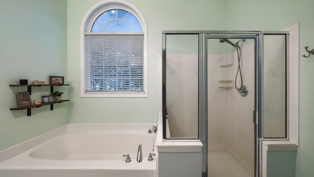 8680 Copperridge Drive Winston, GA 30187 - Photo 40 of 58 a bathroom with a tub a window and a shower