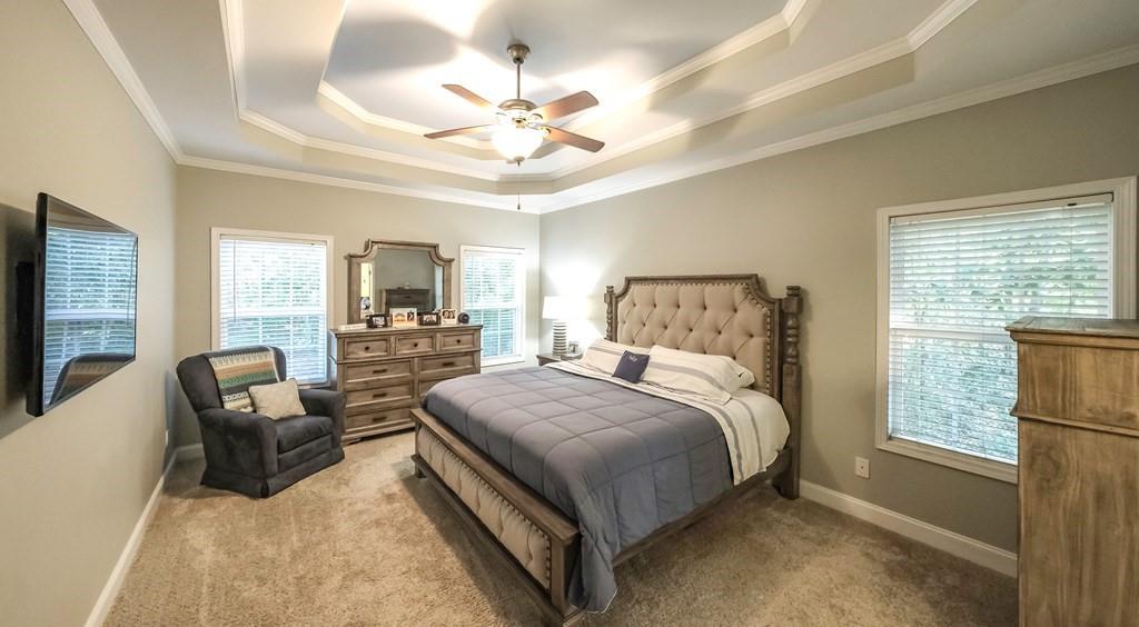 8680 Copperridge Drive Winston, GA 30187 - Photo 45 of 58 a spacious bedroom with a bed and a chandelier