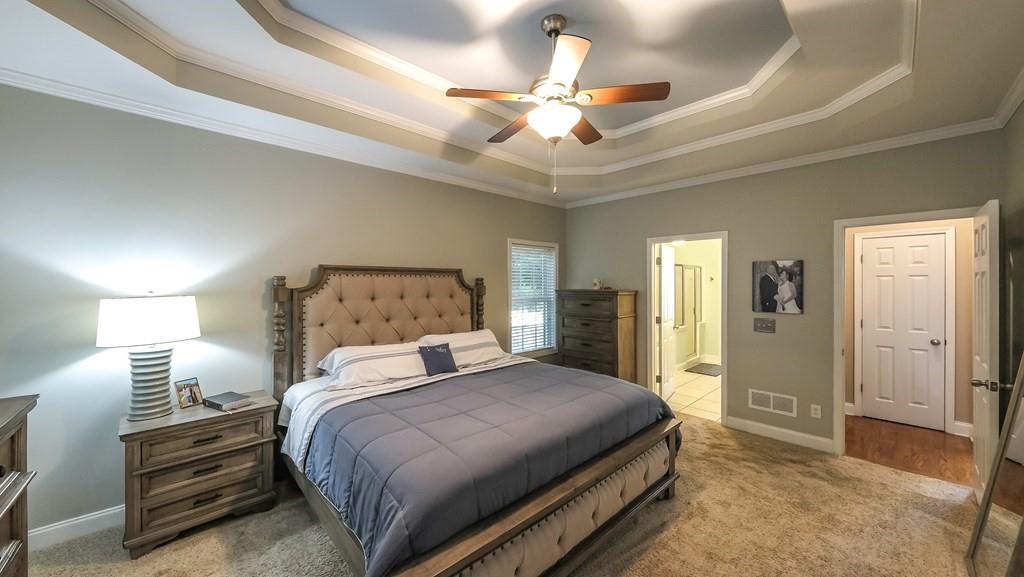 8680 Copperridge Drive Winston, GA 30187 - Photo 48 of 58 a bedroom with a large bed and a chandelier