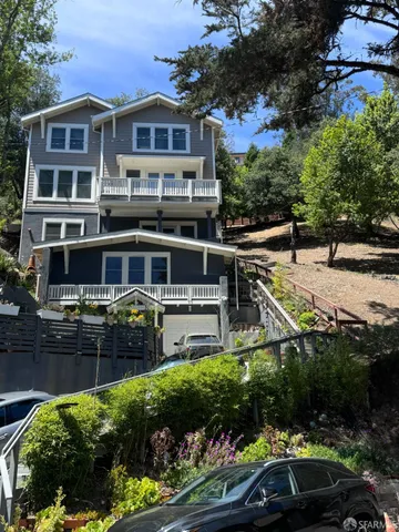 a front view of a house with a garden and pathway