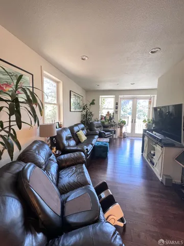 a kitchen with granite countertop lots of clutter and stainless steel appliances