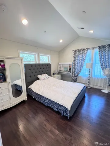 a bedroom with bed and a flat screen tv