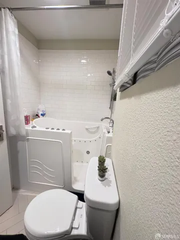 a bathroom with a toilet a sink and a mirror