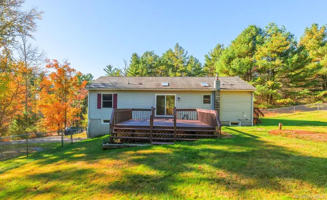 a front view of a house with a yard table and chairs