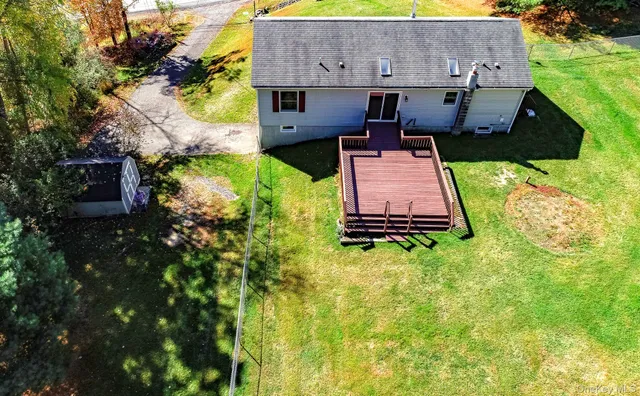 an aerial view of a house with garden space and street view