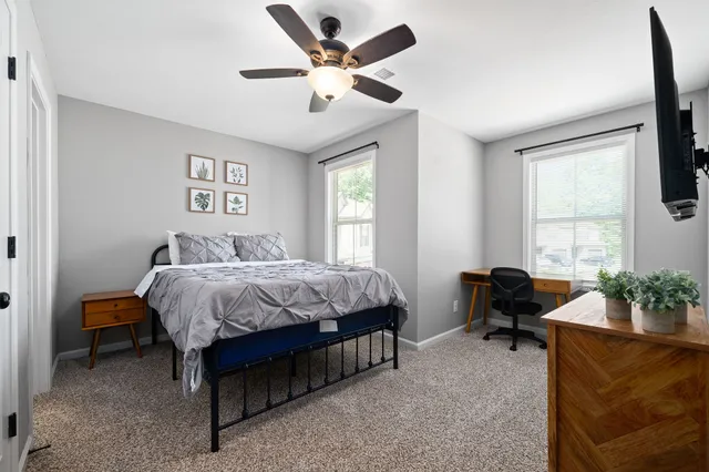 a spacious bedroom with a bed and a window