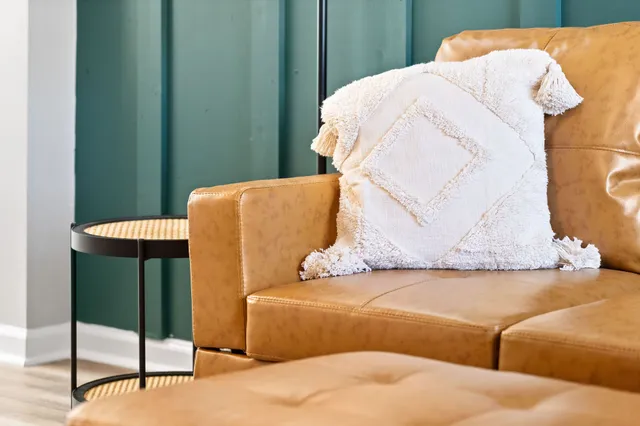 a blue bed sitting in a bedroom next to a window